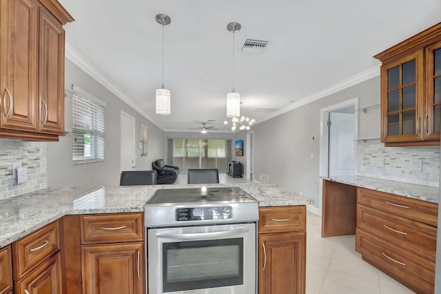 kitchen featuring pendant lighting, stainless steel range, crown molding, and tasteful backsplash