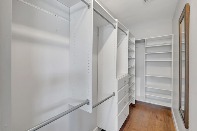 walk in closet featuring dark hardwood / wood-style floors