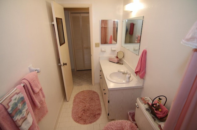 bathroom featuring tile patterned floors, vanity, and toilet