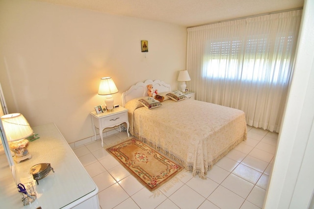 bedroom featuring light tile patterned floors