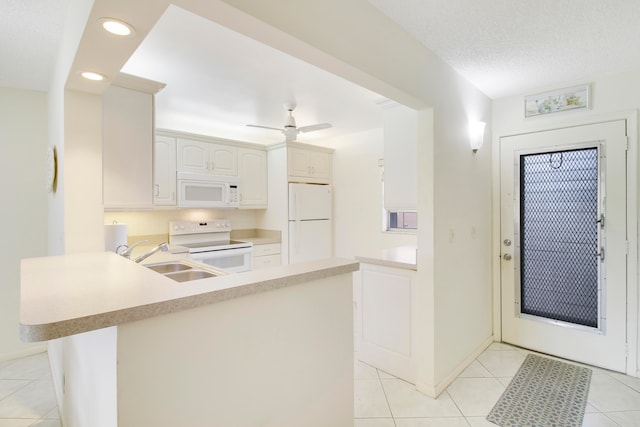 kitchen with ceiling fan, white cabinets, light tile patterned floors, kitchen peninsula, and white appliances