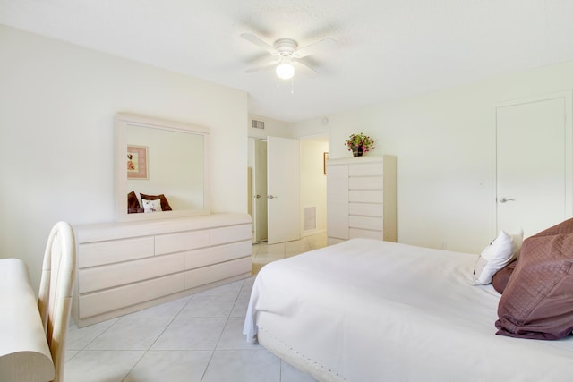 bedroom with ceiling fan and light tile patterned flooring