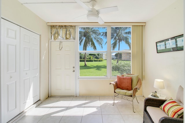 living area featuring ceiling fan and light tile patterned floors