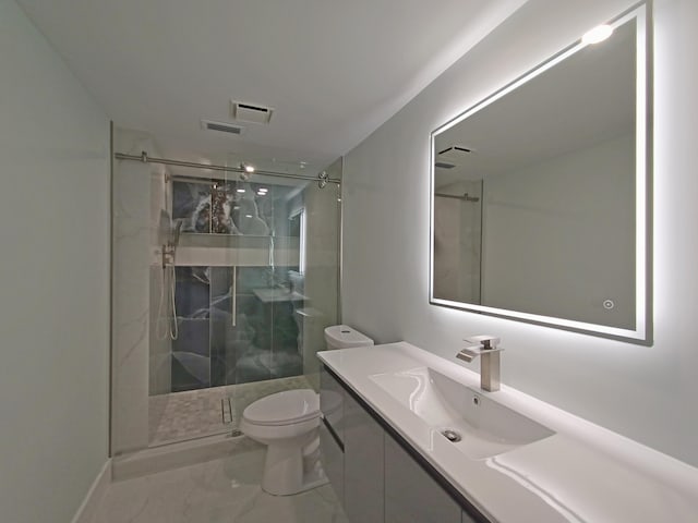 bathroom featuring a shower with door, vanity, and toilet