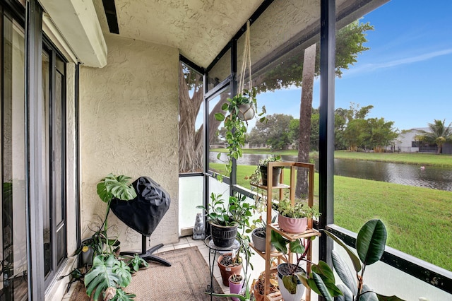 unfurnished sunroom featuring a water view