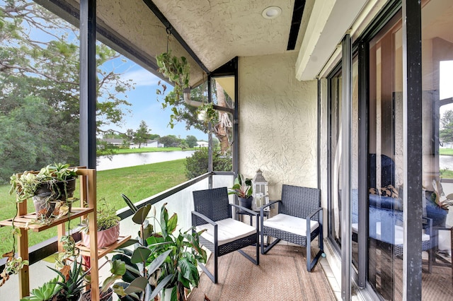 sunroom / solarium with lofted ceiling and a water view