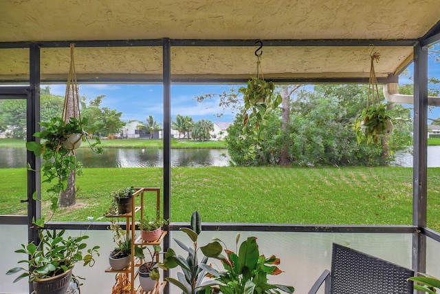 unfurnished sunroom with a water view