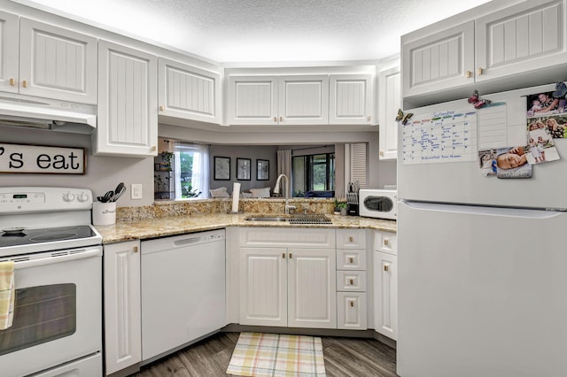 kitchen featuring white cabinetry, dark wood-type flooring, white appliances, a textured ceiling, and sink