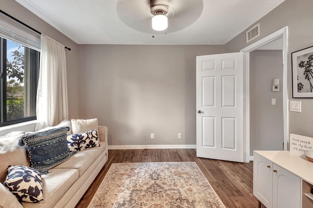 sitting room with ceiling fan and light wood-type flooring