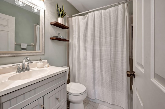 bathroom featuring vanity, toilet, a shower with shower curtain, and tile patterned floors