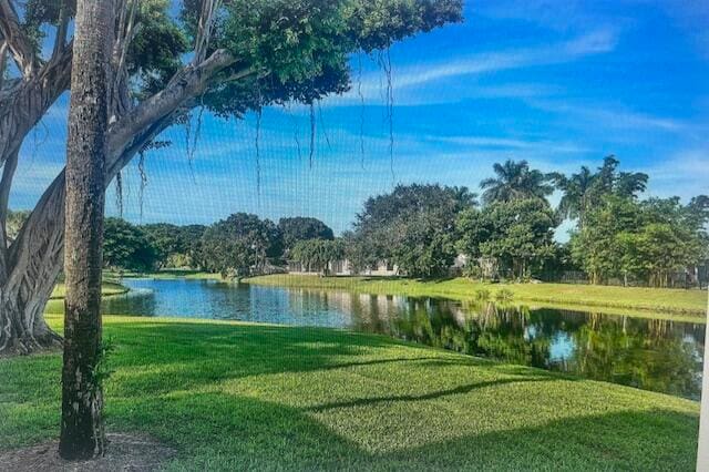 view of property's community featuring a yard and a water view