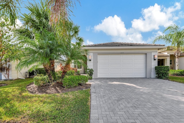 10571 SW Sunray St, Port Saint Lucie, FL 34987 - view of front of property with stucco siding, decorative driveway, and a garage