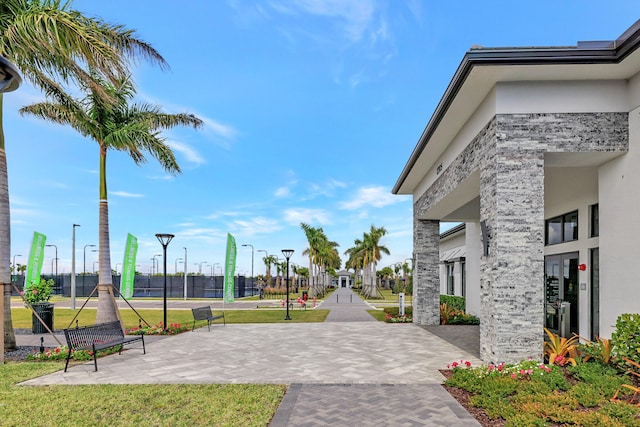 view of community with a patio and a lawn