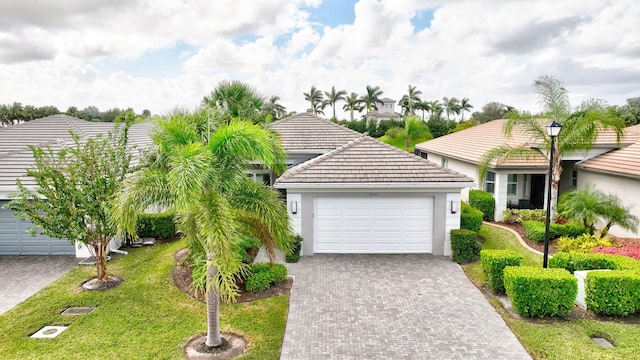 view of front of property with a front yard and a garage