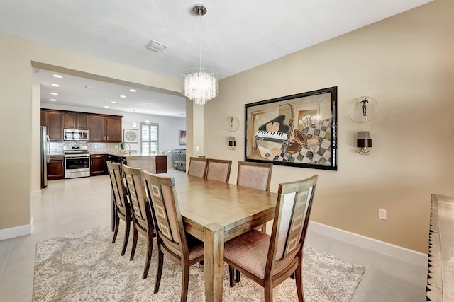 10571 SW Sunray St, Port Saint Lucie, FL 34987 - dining room featuring a chandelier, light tile patterned flooring, recessed lighting, and baseboards