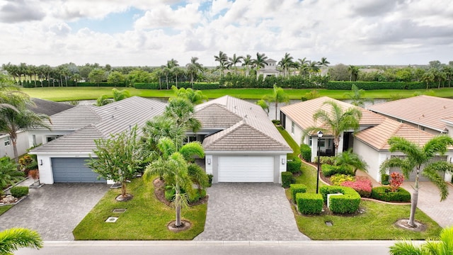 view of front of home with a front yard and a garage