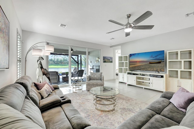 tiled living room with ceiling fan