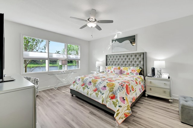 bedroom with light hardwood / wood-style flooring and ceiling fan