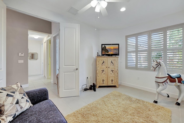 interior space featuring ceiling fan and light tile patterned floors