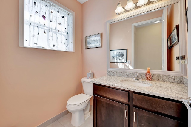 bathroom with vanity, toilet, and tile patterned flooring