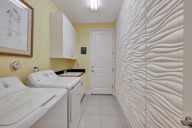 10571 SW Sunray St, Port Saint Lucie, FL 34987 - laundry room featuring separate washer and dryer, cabinet space, light tile patterned flooring, and a textured ceiling