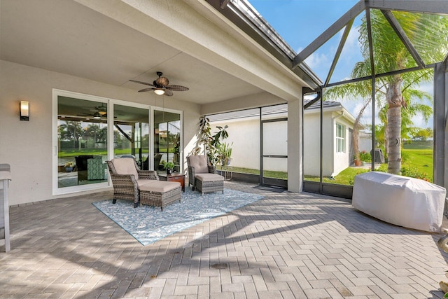 sunroom featuring ceiling fan