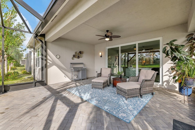 view of patio / terrace featuring ceiling fan and glass enclosure