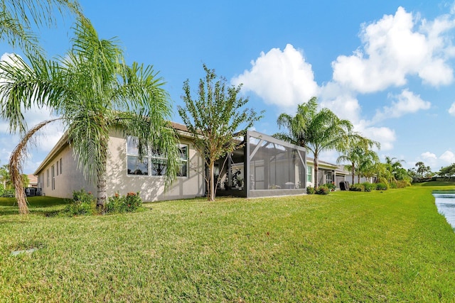 10571 SW Sunray St, Port Saint Lucie, FL 34987 - view of front facade with a front lawn, stucco siding, and glass enclosure