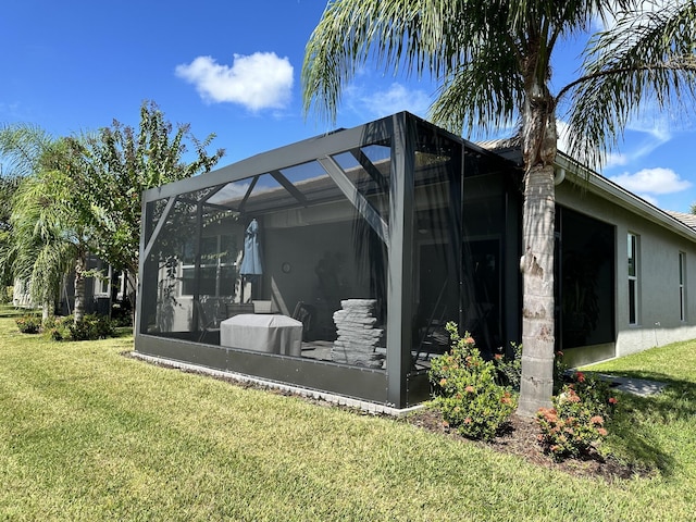 10571 SW Sunray St, Port Saint Lucie, FL 34987 - rear view of property with a yard, stucco siding, and glass enclosure