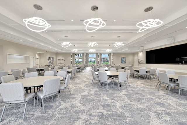 carpeted dining area featuring a raised ceiling and an inviting chandelier