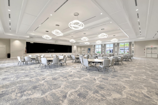 carpeted dining room with a raised ceiling