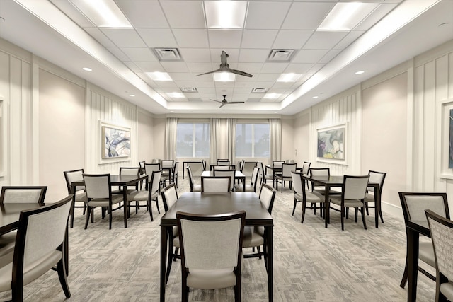 dining room featuring a paneled ceiling, a tray ceiling, and ceiling fan