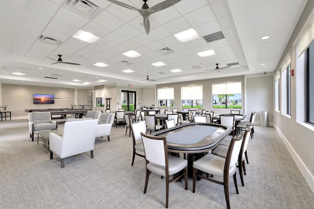 dining space with a tray ceiling, a drop ceiling, and light colored carpet