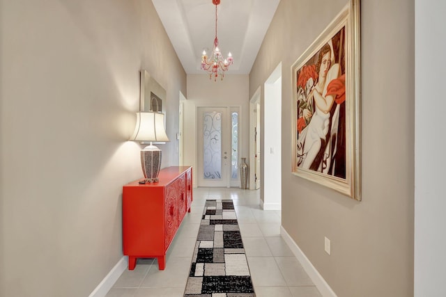 10571 SW Sunray St, Port Saint Lucie, FL 34987 - foyer entrance with a chandelier, baseboards, and tile patterned floors