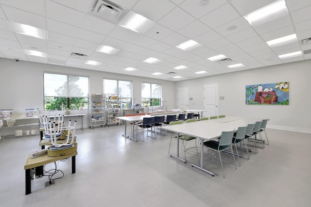 dining space with a drop ceiling