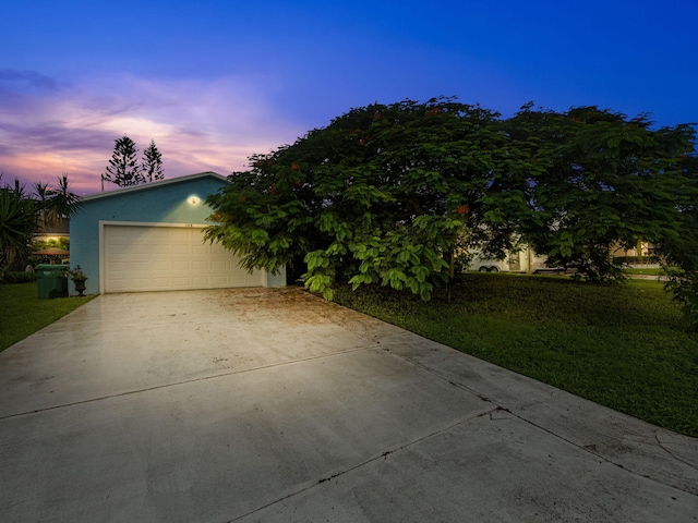 view of front of property featuring a lawn and a garage