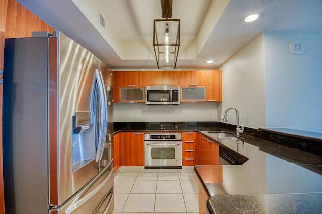 kitchen featuring appliances with stainless steel finishes, modern cabinets, a sink, and brown cabinets