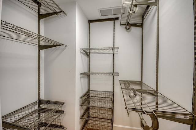 spacious closet featuring visible vents