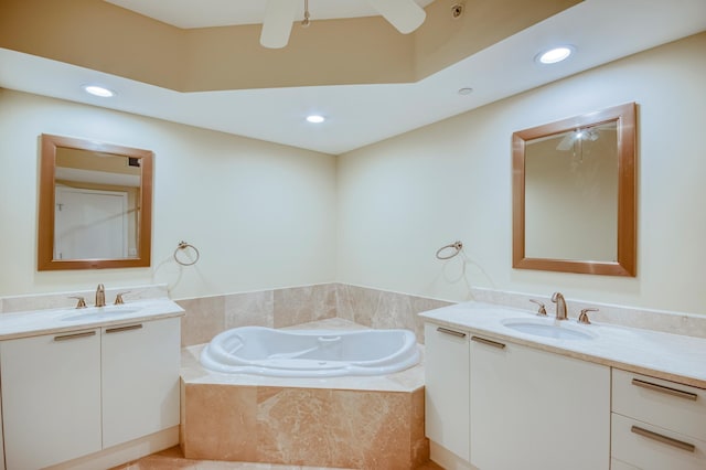 full bath with two vanities, a sink, and a bath