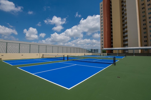 view of tennis court featuring fence