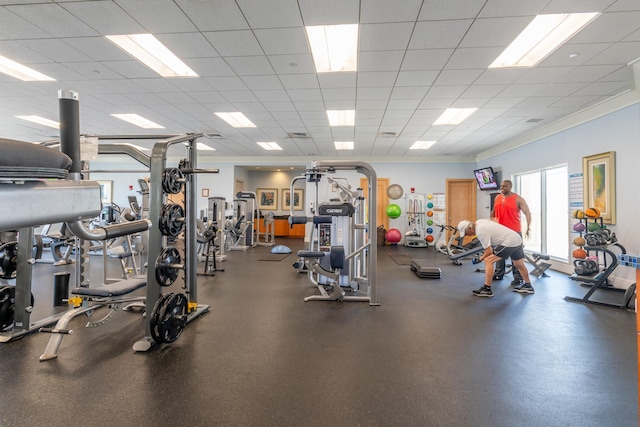 workout area with a paneled ceiling and crown molding