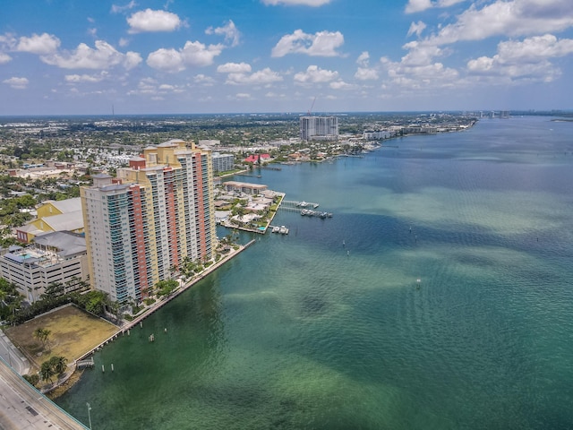 drone / aerial view featuring a view of city and a water view