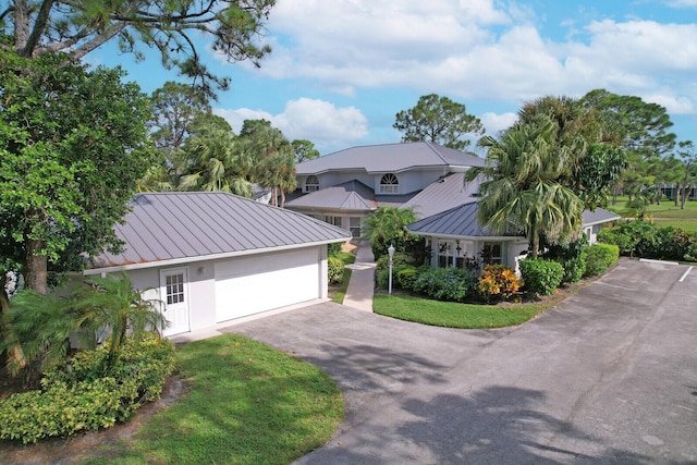 view of front of house with a front lawn and a garage