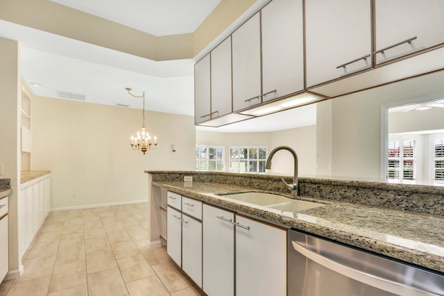 kitchen featuring dishwasher, light stone countertops, sink, and white cabinetry