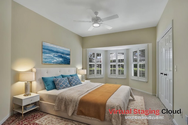 carpeted bedroom featuring ceiling fan and a closet