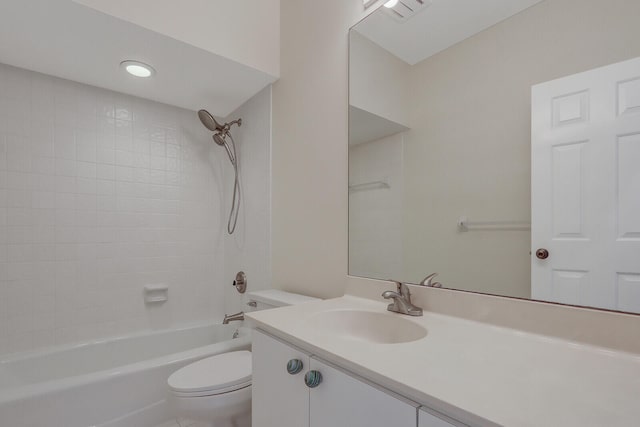 full bathroom with tiled shower / bath combo, vanity, and toilet