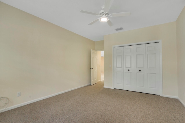 unfurnished bedroom featuring a closet, ceiling fan, and carpet floors