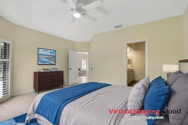 bedroom with multiple windows, carpet, connected bathroom, and ceiling fan