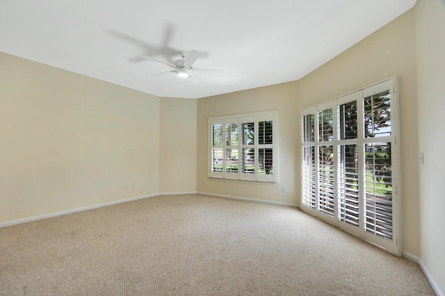 unfurnished room with ceiling fan and light carpet