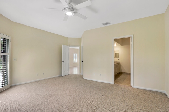 unfurnished bedroom featuring multiple windows, ceiling fan, and light colored carpet